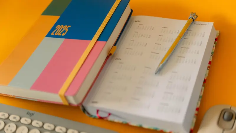 A planner and calendar on a desk
